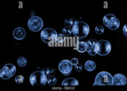 blue, white soap bubbles on black background Stock Photo