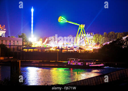 illuminated Cranger Kirmes, biggest funfair of North Rhine-Westphalia, near the Rhine-Herne Canal in the evening, Germany, North Rhine-Westphalia, Ruhr Area, Herne Stock Photo