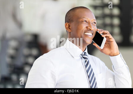 modern African corporate worker talking on cell phone in office Stock Photo