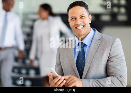 smiling middle aged businessman using smart phone Stock Photo