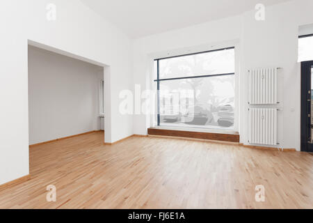 renovated room with shopping window - empty store / shop with wooden floor and white walls Stock Photo
