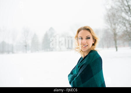 Blond woman throwing her hair outside in winter nature Stock Photo