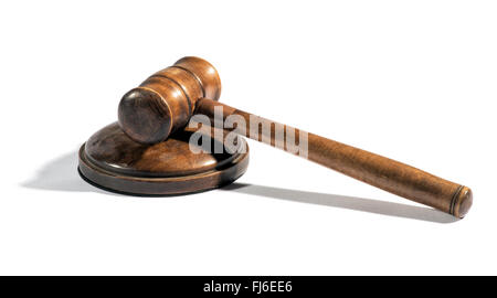 Old wooden judges gavel lying on a plinth over white with a shadow conceptual of law enforcement, justice and sentencing Stock Photo