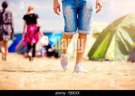 Unrecognizable teenage couple, tent festival, sunny summer, legs Stock Photo
