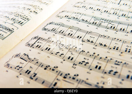 Old open music score with a printed composition of classical music for a piano or orchestra Stock Photo