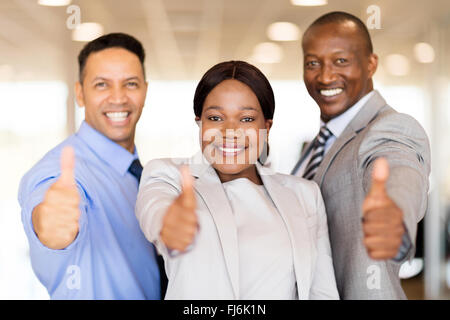 portrait of beautiful car dealership staff giving thumbs up Stock Photo