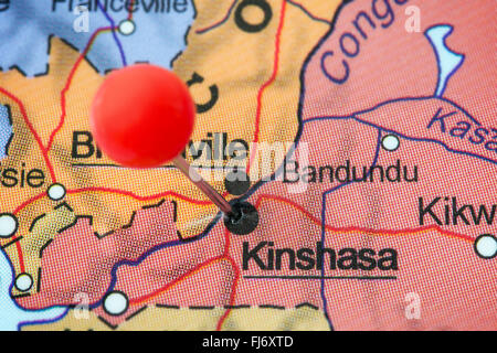 Close-up of a red pushpin in a map of Kinshasa, Democratic Republic of the Congo. Stock Photo