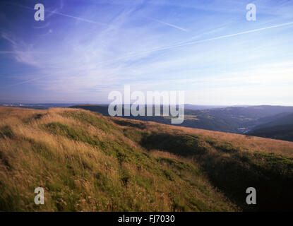 View from Iron Age hillfort earthwork on summit of Twmbarlwm mountain View towards Risca Caerphilly South Wales UK Stock Photo