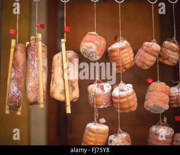 Dried meats and salamies hanging outside shop, Province of Lucca, Tuscany Region, Italy Stock Photo