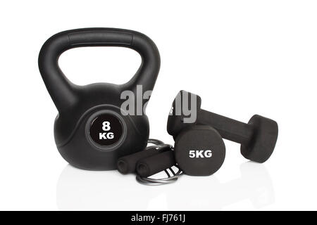 Black dumbbells and kettlebell isolated on white background. Weights for a fitness training. Stock Photo
