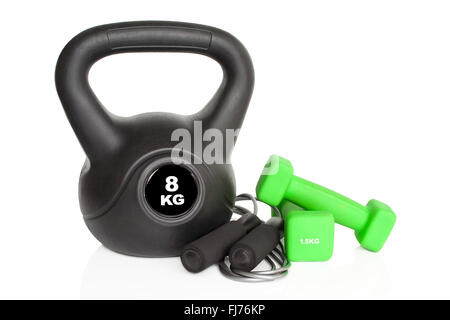 Dumbbells, kettlebell and skipping rope isolated on white background. Weights for a fitness training. Stock Photo
