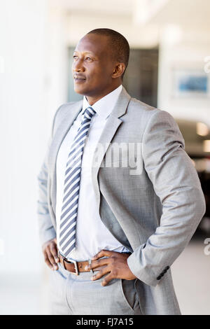 thoughtful businessman looking through office window Stock Photo