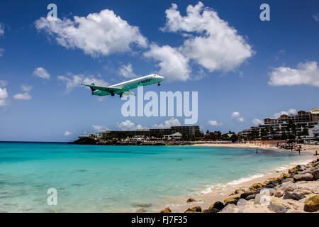 Airplane Insel Air is landing on Princess Juliana International Airport at St.Martin over Maho Bye Beach Stock Photo