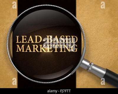 Lead-Based Marketing through Loupe on Old Paper. Stock Photo