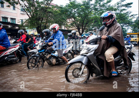 Tangerang, Indonesia. 29th Feb, 2016. Indonesian ride their motorcycles and pass through the flooded road caused by heavy rains in Tangerang. Seasonal rains and high tides in recent days have caused widespread flooding across much in Indonesia. Credit:  Yuan Adriles/Pacific Press/Alamy Live News Stock Photo