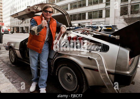 Back to the Future Marty McFly impersonator posing next to DeLorean time machine - Washington, DC USA Stock Photo