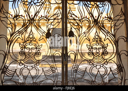 Metal door ornate with Buddhas, Pha That Luang, Vientiane, Laos, East Asia Stock Photo