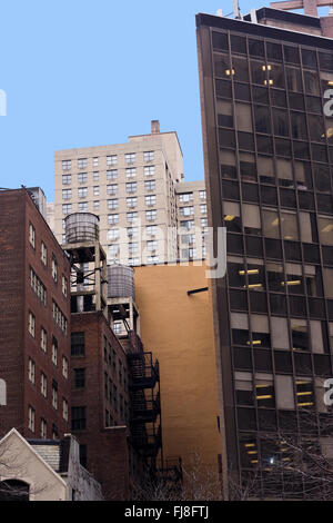 Iconic Wooden Water Towers atop New York City buildings in downtown Manhattan on Broadway and 60th Street Stock Photo