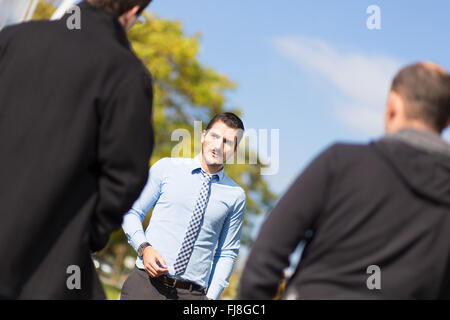 Businessman being approached and blackmailed by two racketeers. Stock Photo