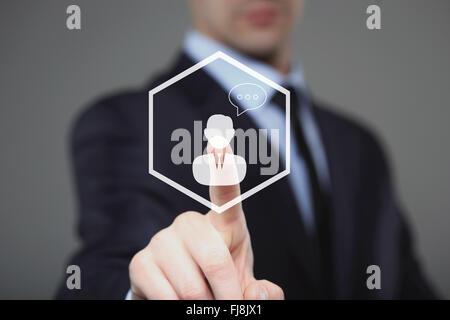 Businessman clicking on live chat icon Stock Photo