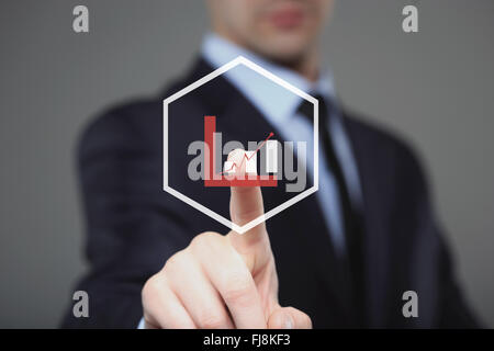 Businessman Touching a Graph Indicating Growth Stock Photo