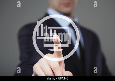 Businessman Touching a Graph Indicating Growth Stock Photo