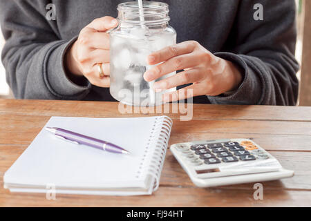 Woman's hand holding a cold glass of water, stock photo Stock Photo