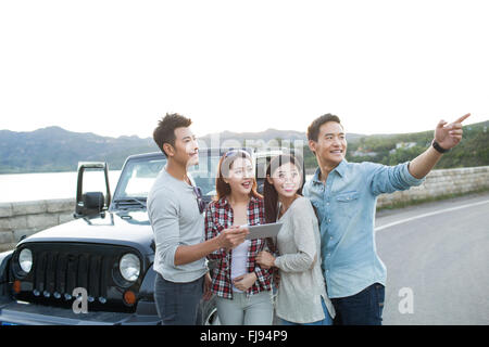 Happy Chinese friends with digital tablet Stock Photo