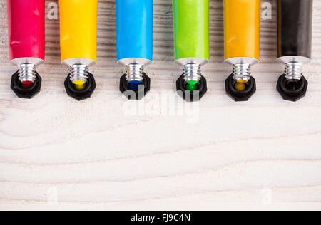 Color tempera water based paints on light wooden surface Stock Photo
