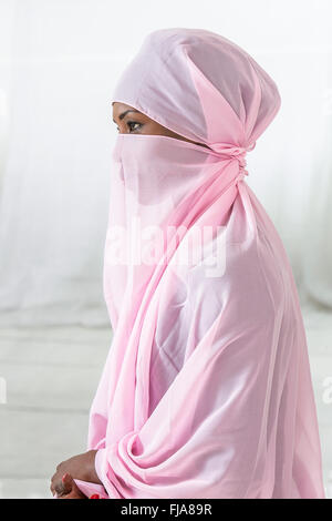 Beautiful  black african muslim woman wearing pink headscarf Stock Photo