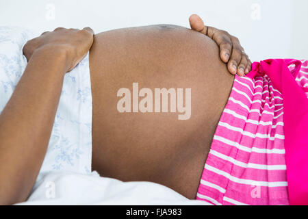 Mid section of woman touching her belly Stock Photo
