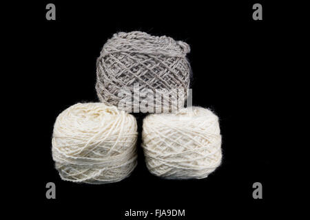 Three balls of wool on a black background Stock Photo