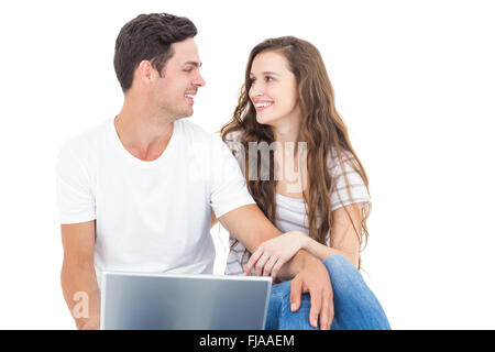Young couple sitting on floor using laptop Stock Photo