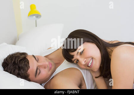 Young couple embracing on bed Stock Photo