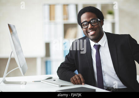 Elegant businessman in suit and eyeglasses looking at camera Stock Photo