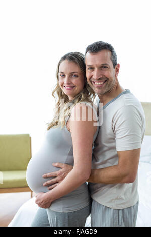 Man holding pregnant womans stomach Stock Photo