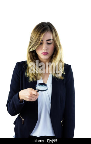 Woman using magnifying glass Stock Photo