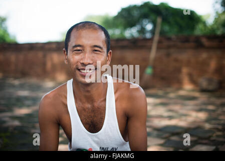 BAGAN, MYANMAR--A local artisan selling his paintings at Abeyadana Temple in Bagan. Located just south of Myinkaba Village in the Bagan Archeological Zone, Apeyadana Temple is named after Apeyadana, an 11th century chief queen consort of King Kyansittha of the Pagan Dynasty of Burma (Myanmar) and maternal grandmother of King Sithu I of Pagan. As with most Burmese names, it is transliterated into English in various ways. Other variations include Ape-ya-da-na, Ape-Yadana-Phaya, and Abeyadana. Stock Photo