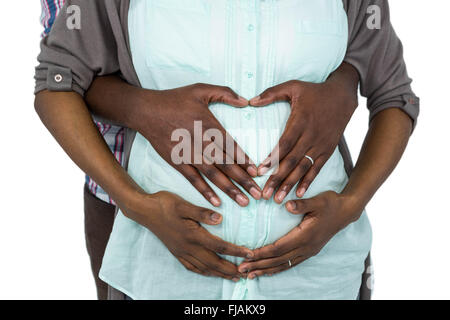Couple making a heart shape on belly Stock Photo