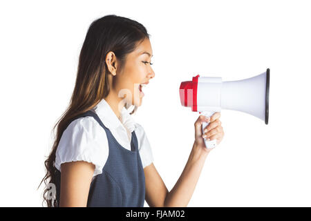 Businesswoman shooting through a megaphone Stock Photo