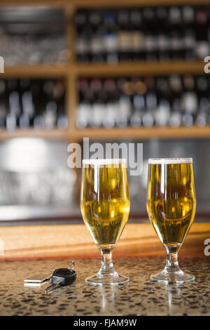 View of two pints of beer and car keys
