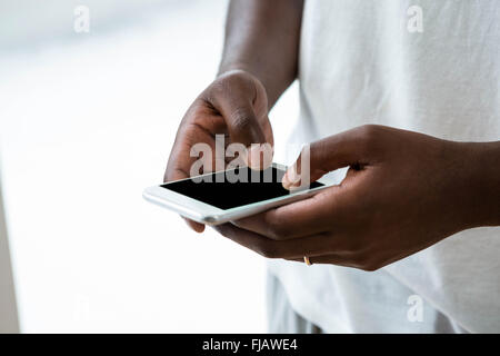 Man text messaging on mobile phone Stock Photo