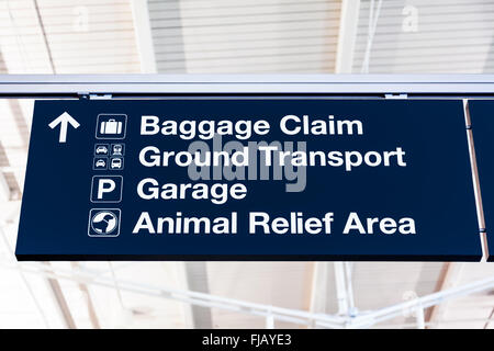 Airport baggage claim sign with Ground Transport, Garage, and Animal Relief Area. Stock Photo