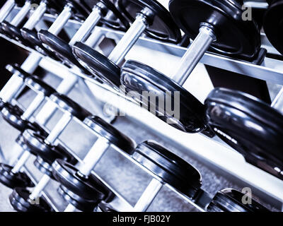 Dumbbell weights on a rack at a healthclub gym Stock Photo