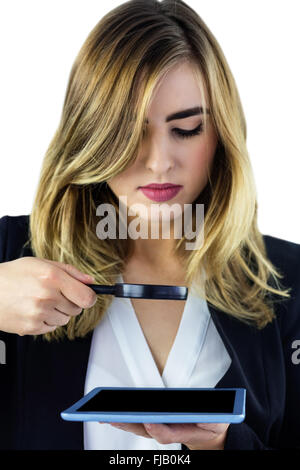 Woman using magnifying glass Stock Photo