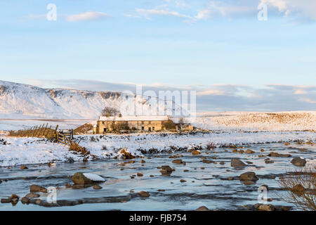 Wheysike House and Cronkley Fell Across Harwood Beck in Winter Viewed from the Pennine Way Footpath, Forest in Teesdale, County Stock Photo
