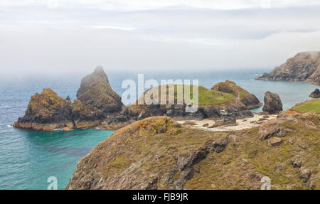 Cornish coastline panorama near Kynance Cove with sandy beach, turquoise sea, rugged rocks  on a summer foggy day, Cornwall, Liz Stock Photo