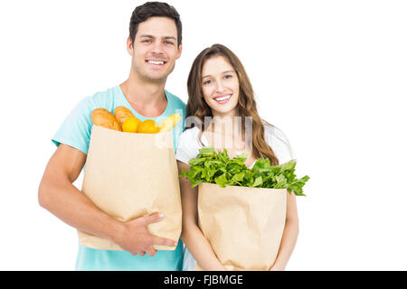 Happy couple carrying grocery bags Stock Photo