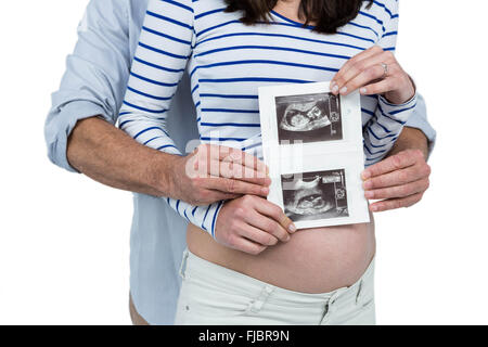 Pregnant couple holding ultrasound scan Stock Photo