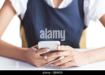 Businesswoman using her smartphone Stock Photo